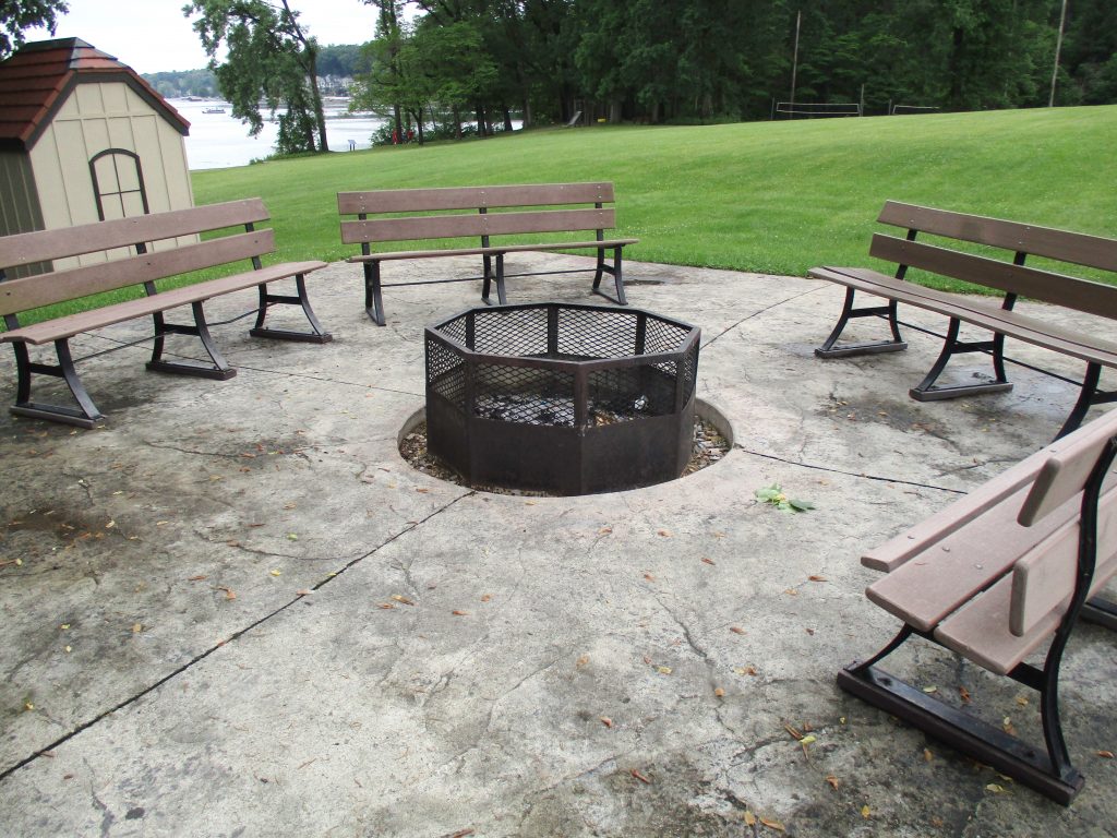 A park fire pit surrounded by benches