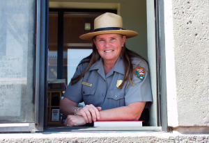 A park ranger at a checkpoint window