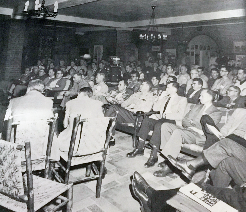 Vintage photo of many seated people attending an early GLPTI meeting