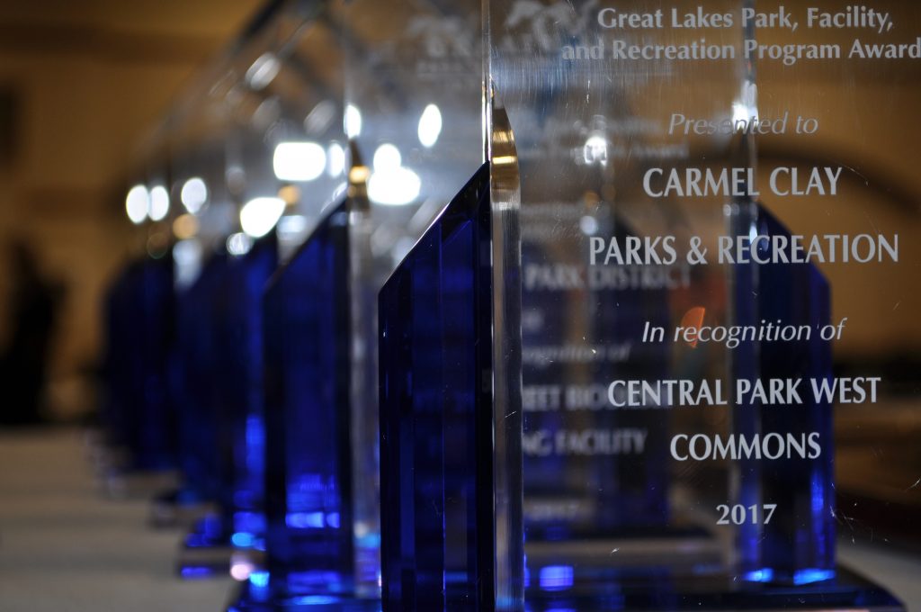 A row of Great Lakes Park, Facility, and Recreation Program Award trophies
